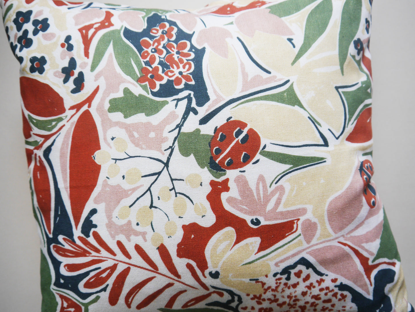 Nature's Delight Cushion: Ladybirds, Leaves, and Buds